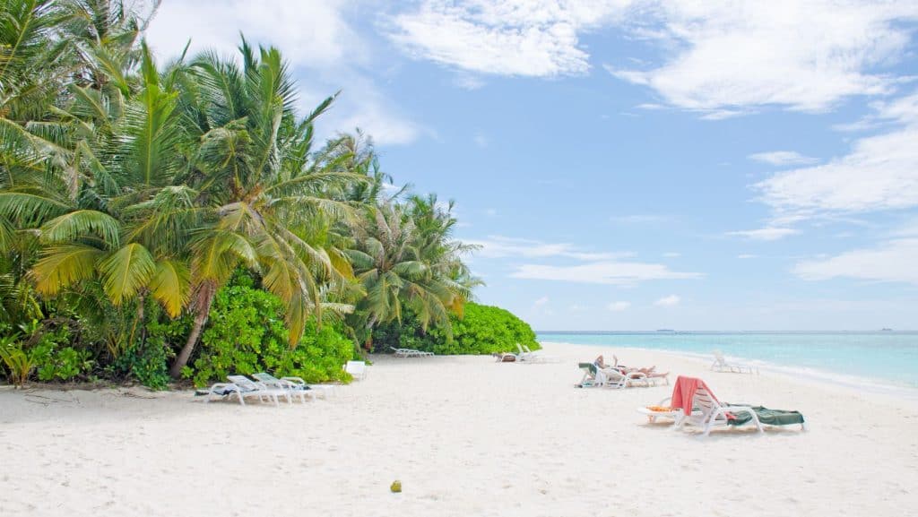 O plajă exotică cu șezlonguri și nisip alb din insula Biyadhoo